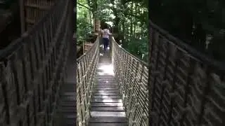 POV walking across the wobbly bridge