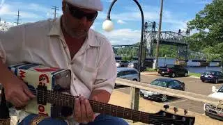 Playing an oil can guitar with a socket