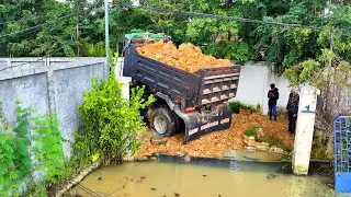 amazing landfill in CHRISTIAN HOUSE flooded area ,truck transport , bulldozer push soil to water