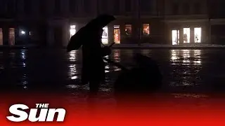 Ukrainians walk down dark streets during blackout amid Russian strikes
