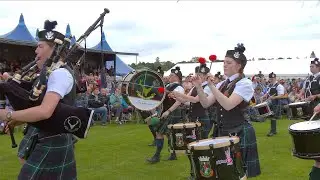 Forres and District Pipe Band playing the march around Games field at 2024 Inverness Highland Games