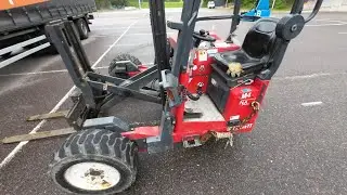 POV Attaching Moffett On The Back Of A Trailer