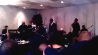 Theo Barnes on stage singing with the band