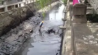 A dirty job cleaning Lindun Lu canal in Suzhou China