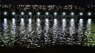 Moscow river embankment restaurant at night reflecting lights on water surface