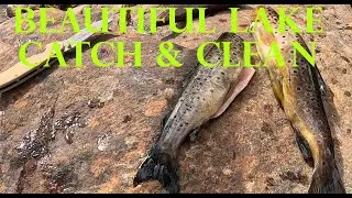 Alpine lake trout fishing, catch and clean.