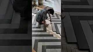 Construction workers install herringbone patterned wood flooring.#shorts #construction ##shortvideo