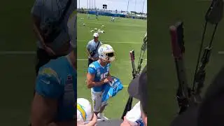 Justin Herbert flashes Red Eyes while signing autographs