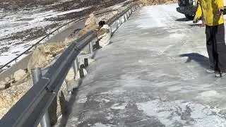 Travelers struggle to keep balance on an icy mountain pass in Yunnan, China