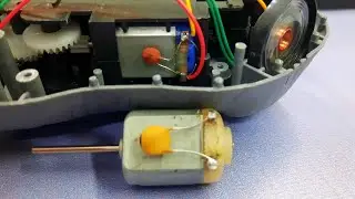 Why is a capacitor used with DC motors in toys