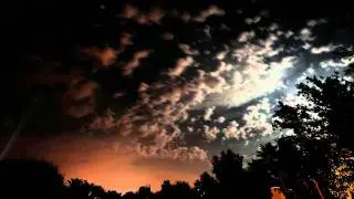 Colorful stars and clouds in moonlight with searchlight timelapse V10020
