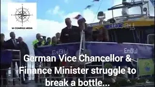 German Vice Chancellor & Finance Minister struggles to break champagne bottle...