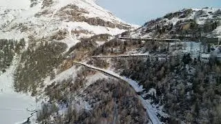 Aerial View of Snowy Mountain Road in Winter