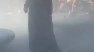 Guy walks through protest in a batman suit