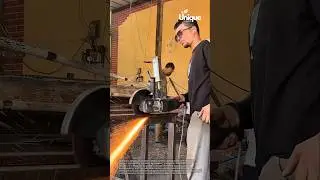 Metal worker cutting metal with angle grinder: sparks flying