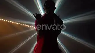 Silhouette a Young Girl Dancer in a Red Sari. Indian Folk Dance. Shot in a Dark Studio with Smok...