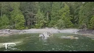 wreck of a fishing boat on the Coast of Canada with a spill boom deployed