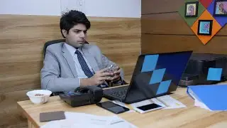 Young Indian businessman drinks a glass of water while working | Indian Stock Footage | Knot9