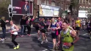 Charlie Dark from Run Dem Crew runs through Mile 21 at Virgin London Marathon 2013