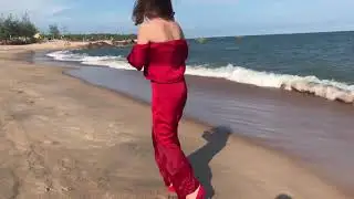 Red high heels and beach