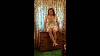 Crossdresser wearing a white satin slip on dresser
