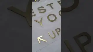 Wayfinding Sign || Flat-cut stainless steel letters with a matte gold finish