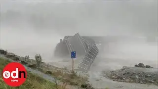 Bridge washed away by raging floodwater in New Zealand