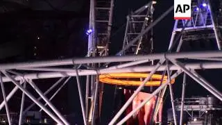 Smoke wafts from stadium as 'forged' rings emerge, 'Queen' parachutes to stadium