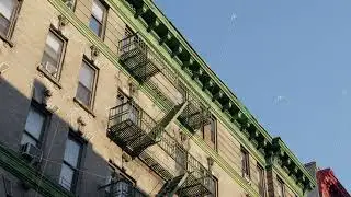 Sunlit Fire Escape in New York City's Manhattan, Capturing the Urban Charm of Brick Architecture and