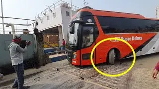 Desh Traveles.Royal Express. SB Super Deluxe. three A/C bus slowly and carefully load  by ferry