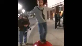 Kid dancing on target red ball