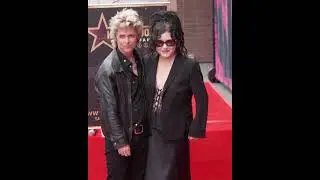 Billie Joe Armstrong and Adrienne Armstrong pose with Green Day's star on the Hollywood Walk of Fame
