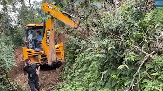 JCB Backhoe Cutting Wet Hillside for Logging Deck Narrow Road