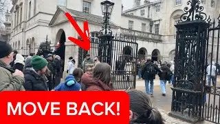 Guard Moves Public Behind Bollards During the Horse Change