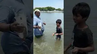 Talented young boy catches three mullet fish using the bottle fishing technique