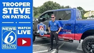 Trooper Steve meets a dog ready for adoption at Orange County Animal Services