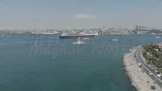 D-Log M. Istanbul, Turkey. Maidens Tower Kiz Kulesi with cargo ship and cruise liners sailing on ...
