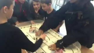 kids take a break from chess to play some hockey