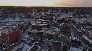 4K drone view of Geneva New York at sunset and full moon in winter