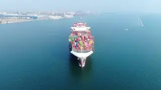 infront of cargo container ship running near