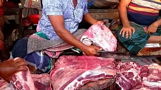 Beef cutting skills by professional butcher at roadside meat shop.Big cow meat cutting skills.