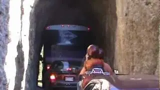 Tour Bus going through the rocks in the Black hills