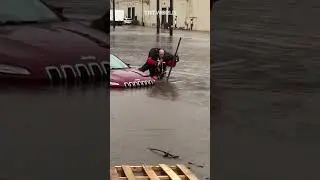 US officer carries driver out of submerged car