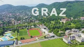 Inscription on video. Graz, Austria. Aerial view of the historic city center. Glitch effect text, Ae