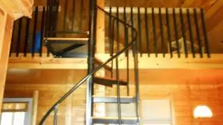 Spiral stairs leading up to a loft bedroom w/queen size bed
