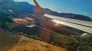Morning above farmland with clouds, Flying high at dawn above agrarian landscape and sky