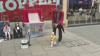 Musician standing outside Burger King with Freddie Mercury & Michael Jackson dolls.
