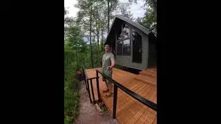 A cabin in the woods, a deck in the breeze, and a view framed by our railing.