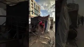 A man with an amputated foot cleans his tent at a shelter center in the Gaza Strip