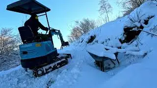 Moving snow on trails with the mini excavator blade